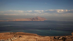 (FILE) A picture taken on January 14, 2014 through the window of an airplane shows the Red Sea's Tiran (foreground) and the Sanafir (background) islands in the Strait of Tiran between Egypt's Sinai Peninsula and Saudi Arabia. Saudi King Salman on April 11, 2016 wrapped up a landmark five-day visit to Egypt marked by lavish praise and multi-billion-dollar investment deals, in a clear sign of support for President Abdel Fattah al-Sisi's regime. Egypt also agreed during the visit to demarcate its maritime borders with Saudi by officially placing the two islands in the Straits of Tiran in Saudi territory.  / AFP / STRINGER        (Photo credit should read STRINGER/AFP/Getty Images)